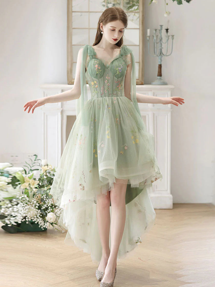 Model wearing an elegant green lace A-line high-low prom dress with a V-neckline.