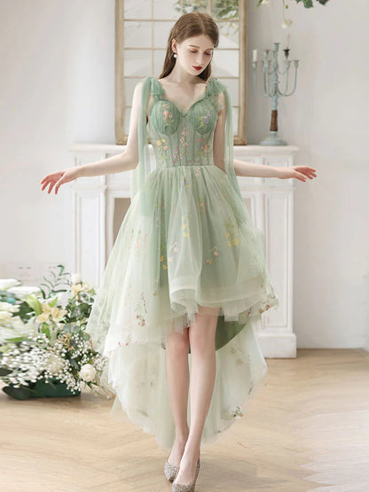 Model wearing an elegant green lace A-line high-low prom dress with a V-neckline.