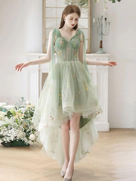 Model wearing an elegant green lace A-line high-low prom dress with a V-neckline.