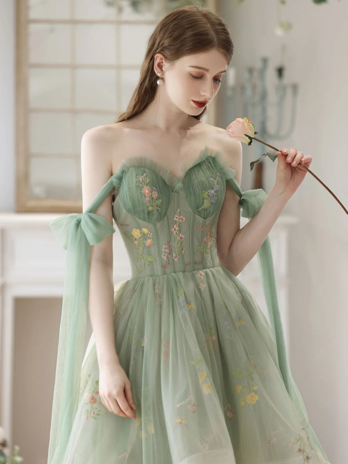 Back view of a green lace A-line high-low formal dress, showcasing the hemline.