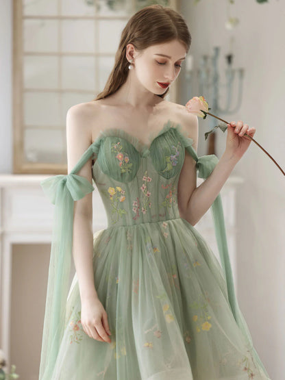 Back view of a green lace A-line high-low formal dress, showcasing the hemline.