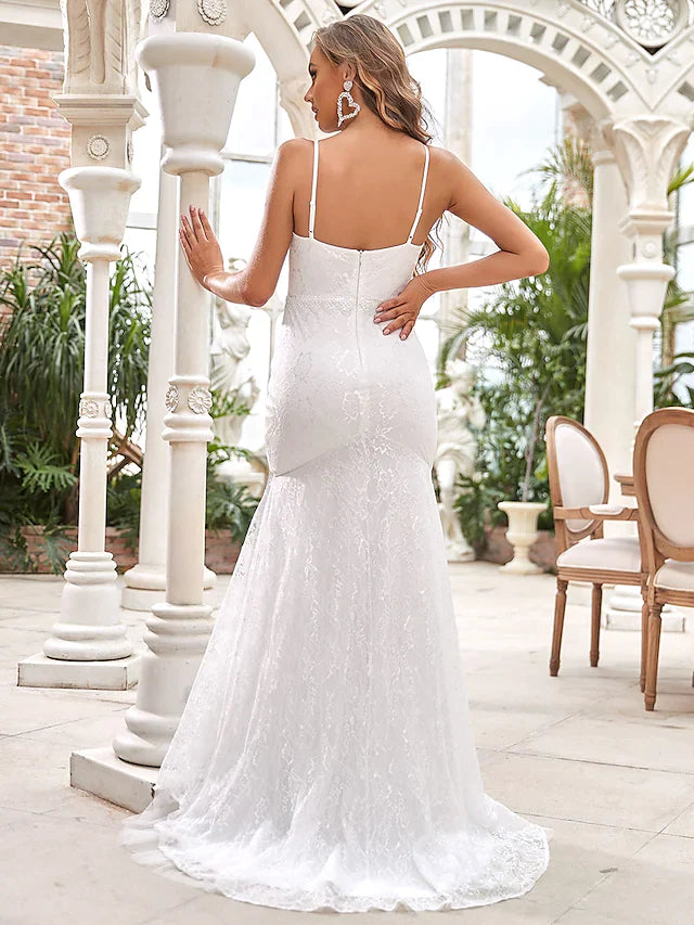Close-up of the V-neckline and intricate lace bodice of the wedding gown.