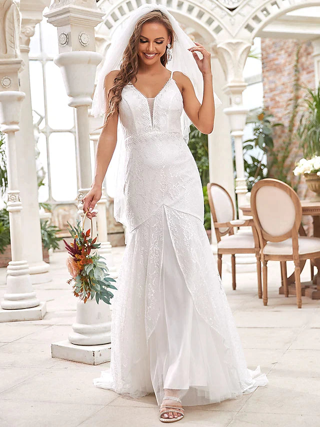 Side profile of a bride in the sleeveless A-line wedding dress with lace details.