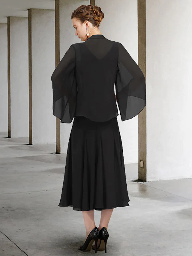 Close-up of the V-neckline and beaded long chiffon sleeves.