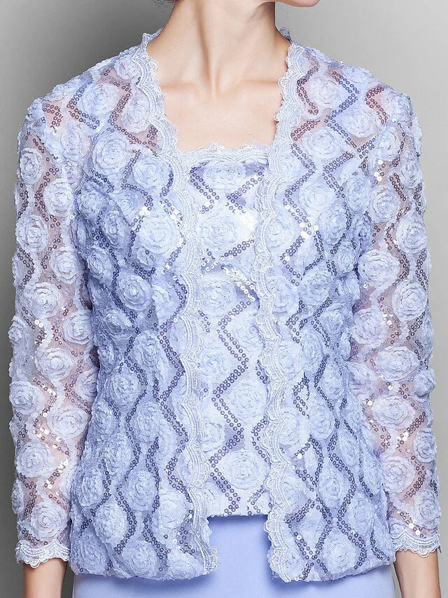 Close-up of the intricate lace and chiffon fabric on the dress sleeve.