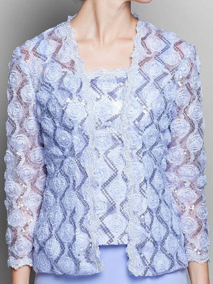 Close-up of the intricate lace and chiffon fabric on the dress sleeve.