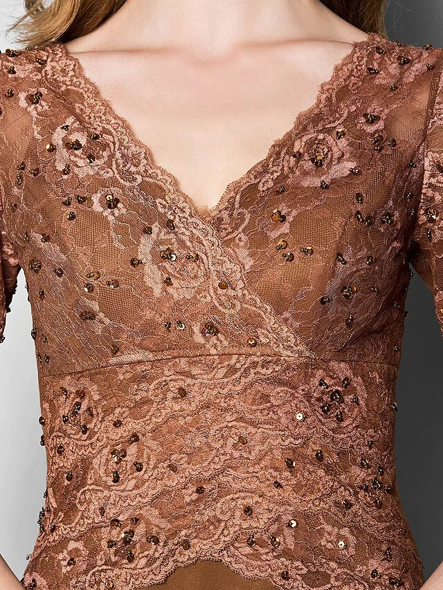 Close-up of intricate lace and beading detail on the V-neck and long sleeve of the dress.
