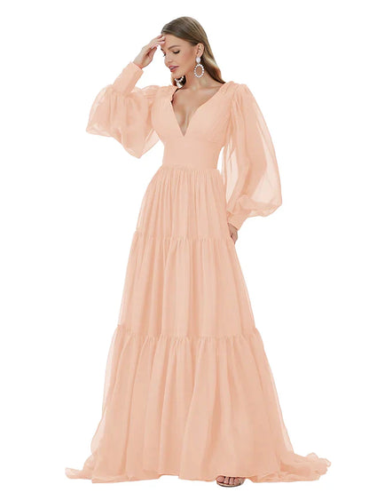 Model wearing a blue A-line V-neck long sleeve ruched chiffon evening gown.