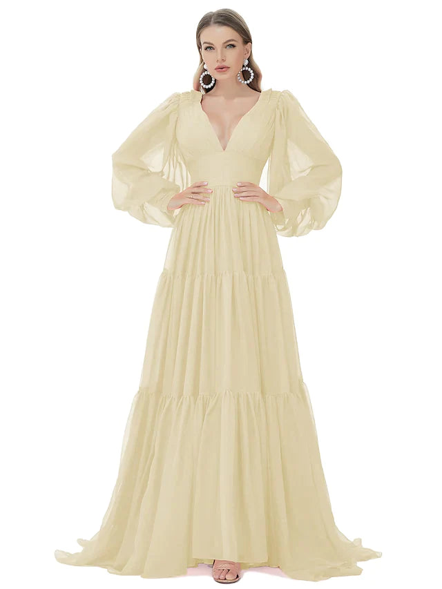 Model gracefully walking in a blue A-line V-neck long sleeve chiffon gown.