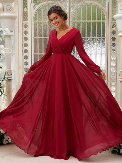 Model posing in a flowing light blue A-line floor-length bridesmaid gown.