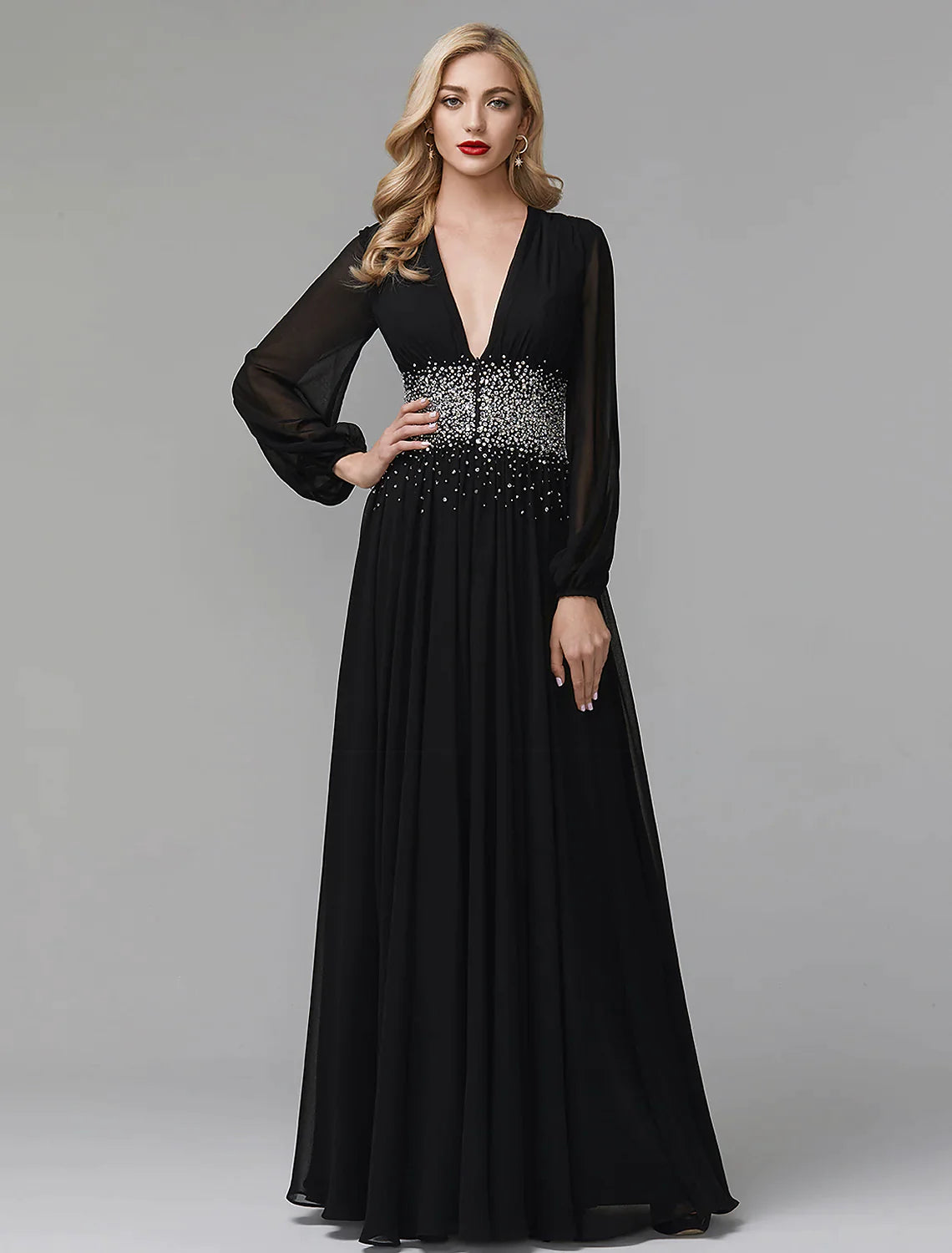 Model posing in a navy blue A-line sequin and chiffon evening gown.