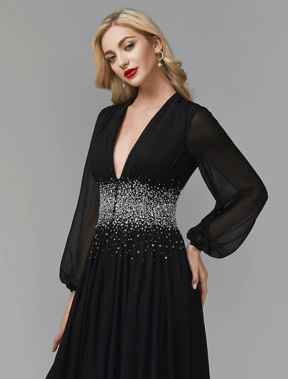 Model showcasing the V-neck and long sleeves of a navy blue A-line evening gown.