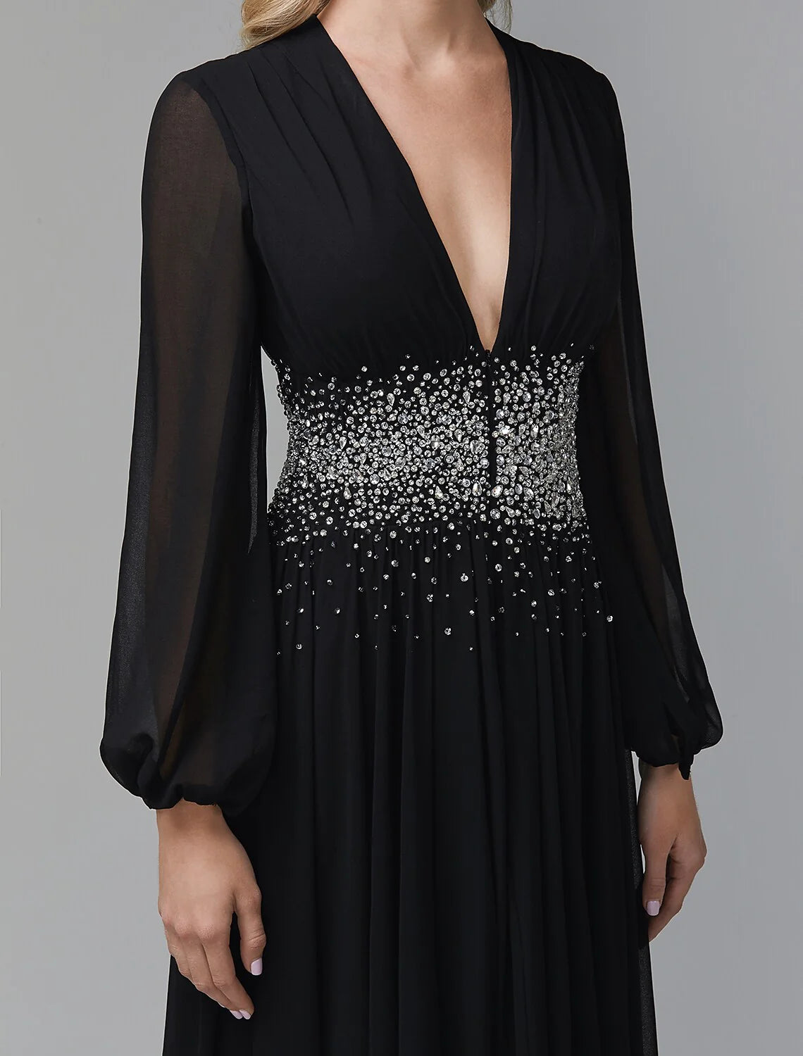 Close-up of the sequin details on the bodice of a navy blue chiffon formal dress.