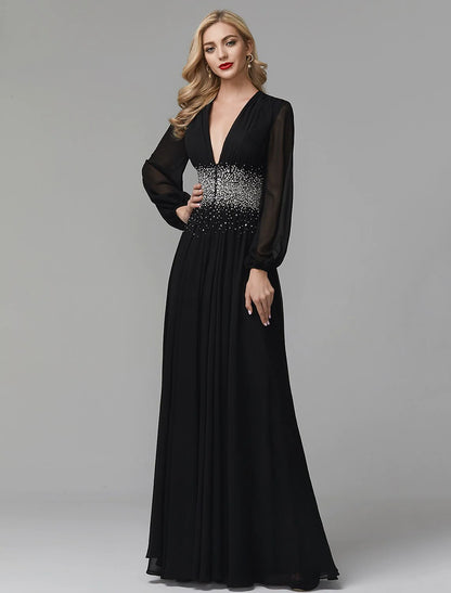 Model standing gracefully in a navy blue A-line V-neck long sleeve sequin chiffon dress.