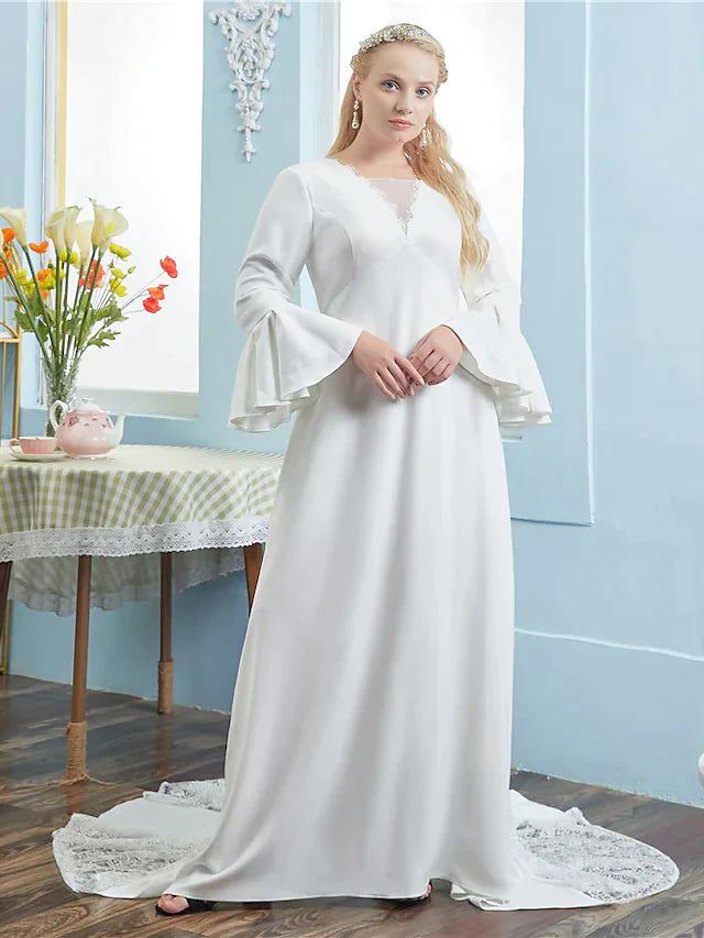 Model wearing an A-line V-neck long sleeve wedding dress with a chapel train.