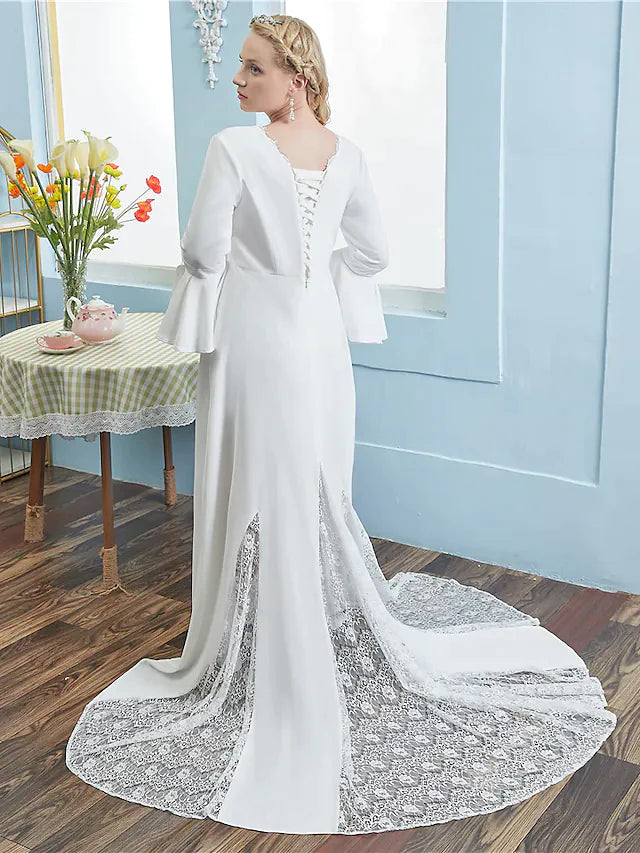 Back view of an A-line wedding dress showing chapel train and lace details.