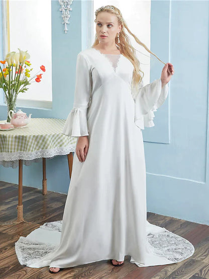 Close-up of the V-neckline and lace sleeves on the wedding dress.