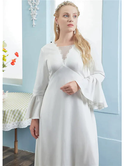 Full length view of an A-line wedding dress with pleats and lace inserts.