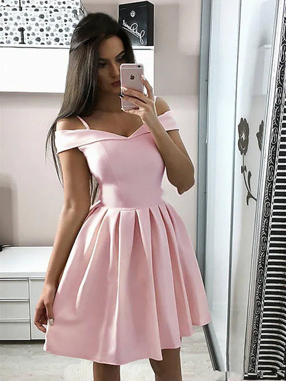 Woman wearing an elegant red A-line V-neck cocktail dress with pleats.