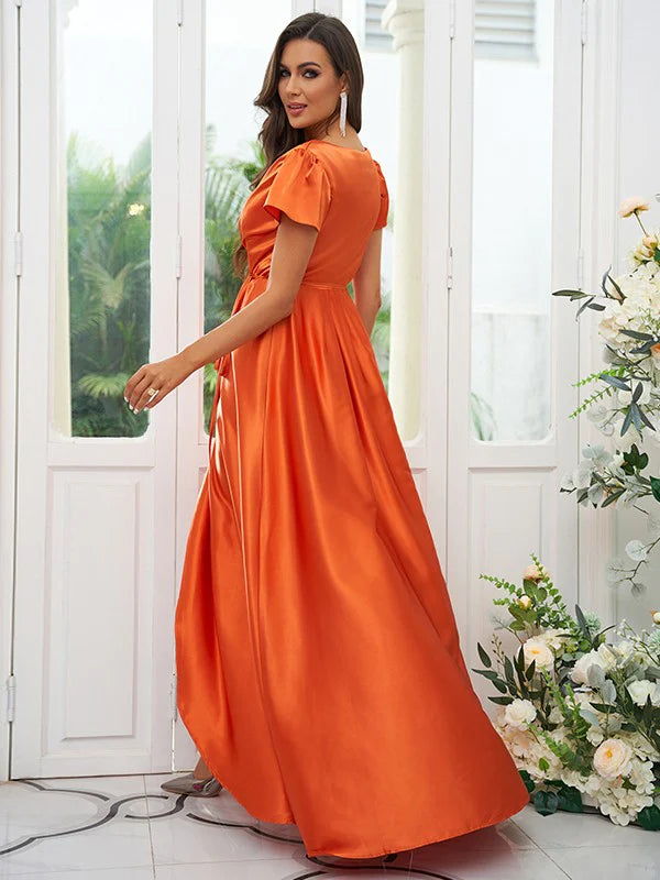 Back view of a woman in an A-line V-neck ruched short sleeve floor-length bridesmaid dress.