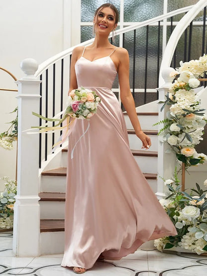 A woman wearing an elegant A-line V-neck ruffled bridesmaid dress in silk-like satin.
