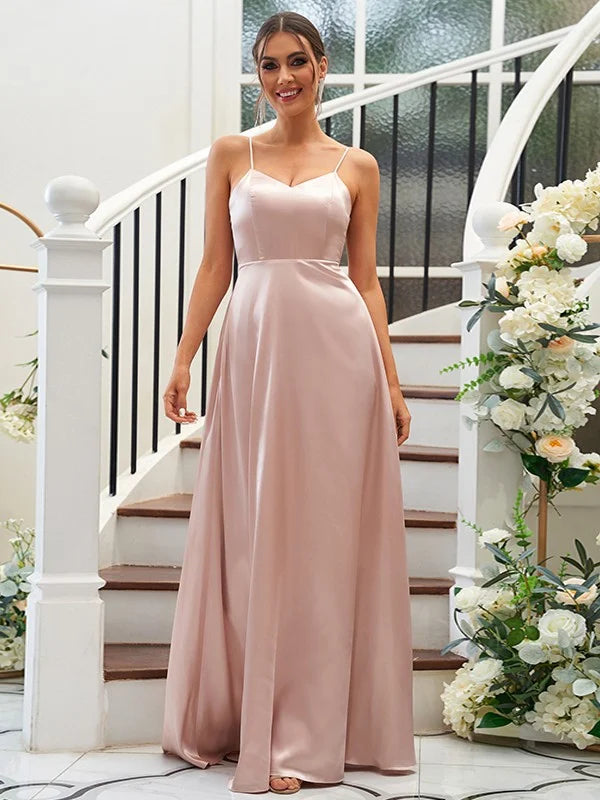 Full-length view of a woman posing in a sleeveless V-neck satin bridesmaid dress.
