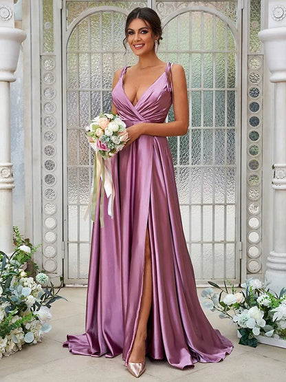 Close-up of the V-neckline and ruffled details on a luxurious silk-like satin dress.