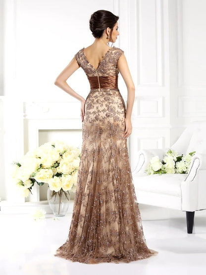 Side view of the long sleeveless A-Line lace dress with ruffles.
