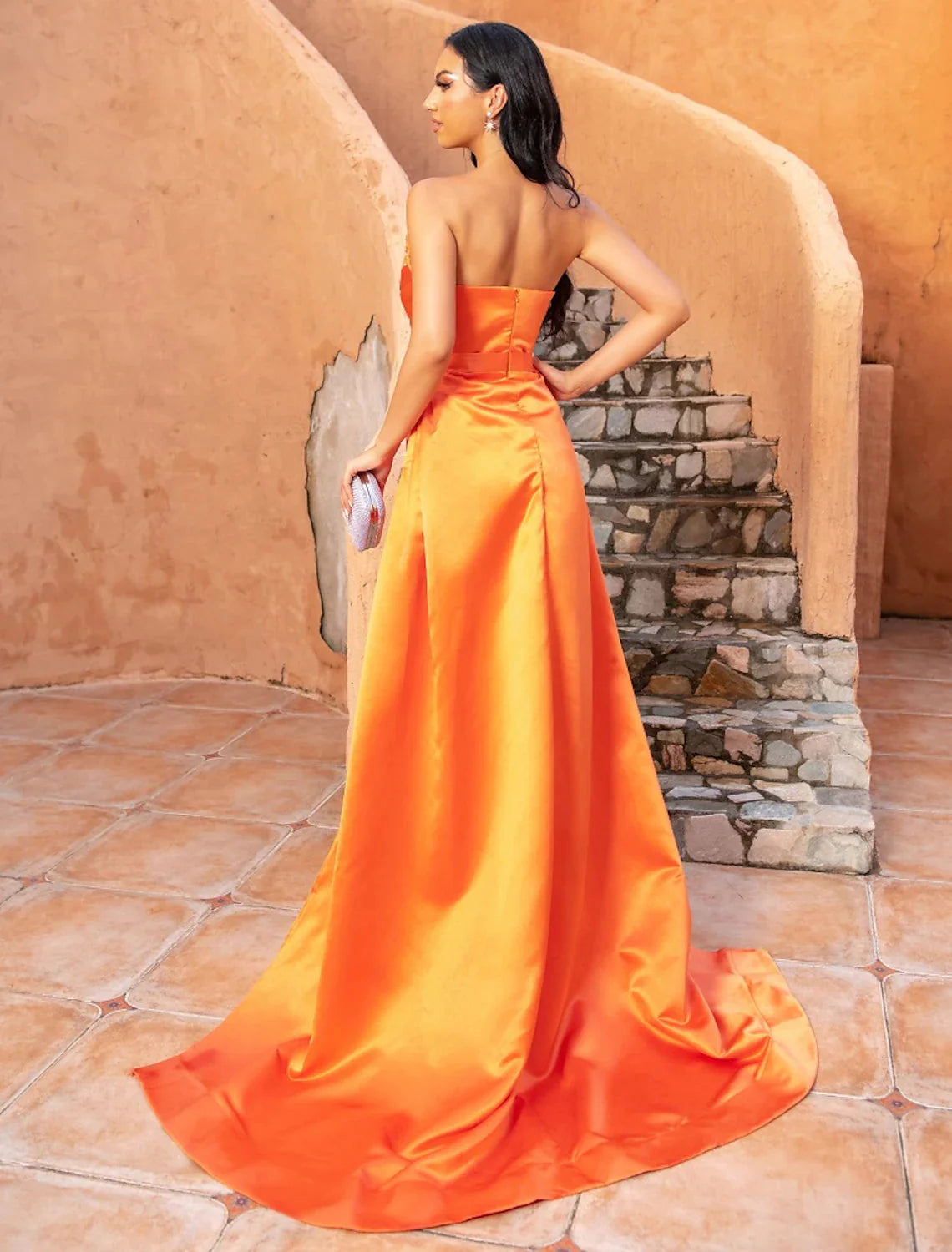 Side view of the dark blue A-line satin evening gown, showing the sweep train and V-neckline.
