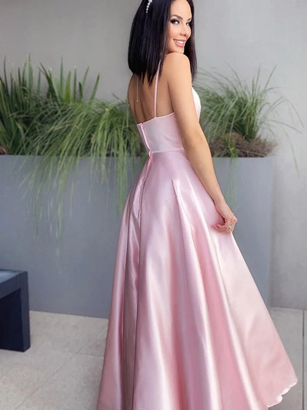 Back view of a woman in a navy blue A-line V-neck satin ruched floor-length prom dress.