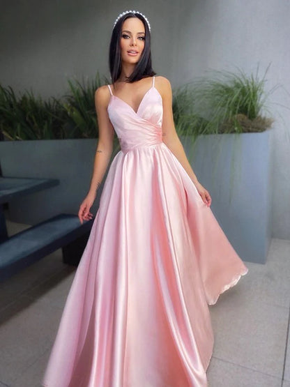 Side view of a woman in a navy blue A-line V-neck satin ruched floor-length prom dress.