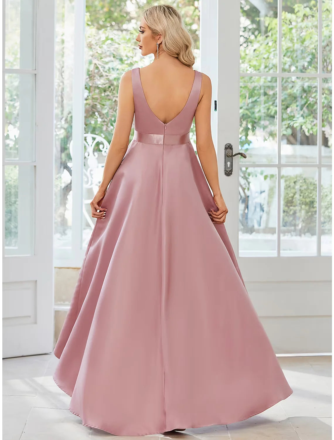 Side view of a model posing in a solid color A-line V-neck sleeveless satin ruffle midi dress.