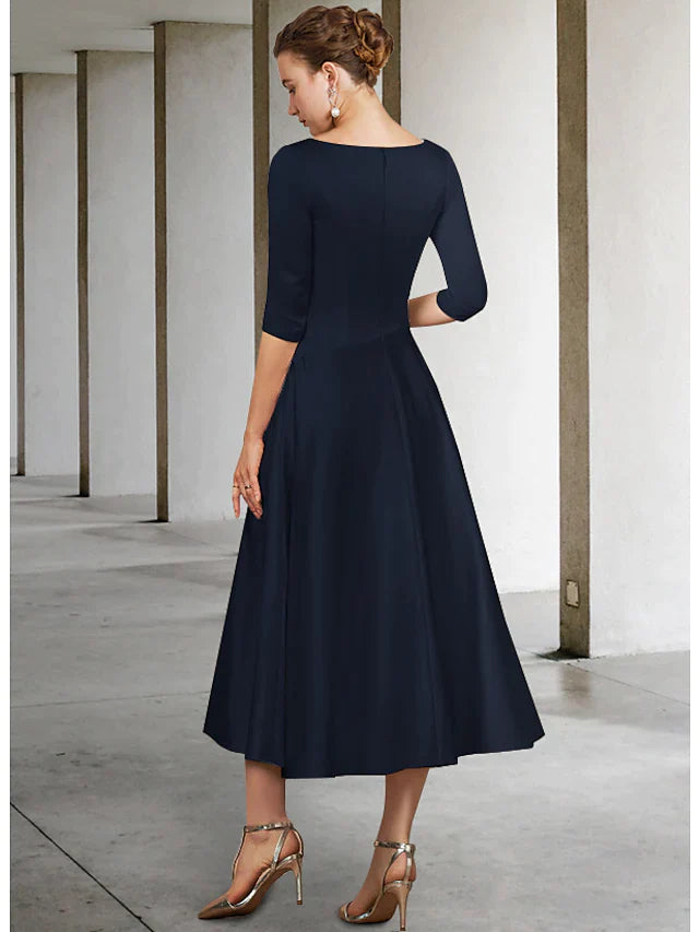 Woman wearing a purple A-line V-neck satin tea length Mother of the Bride dress with half sleeves.