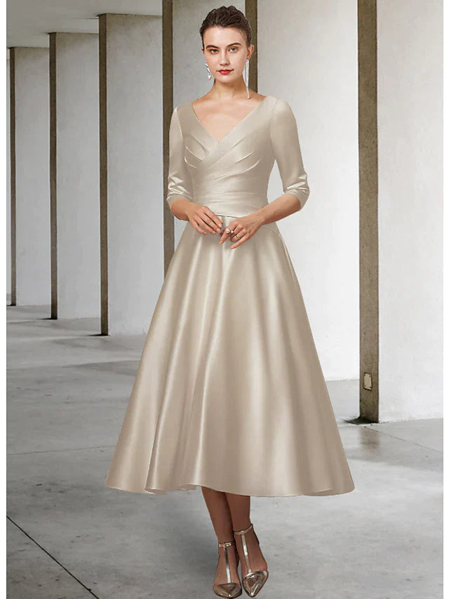 Woman wearing a red A-line V-neck satin tea length Mother of the Bride dress with half sleeves, side view.