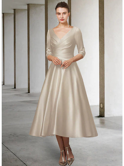 Woman wearing a red A-line V-neck satin tea length Mother of the Bride dress with half sleeves, side view.