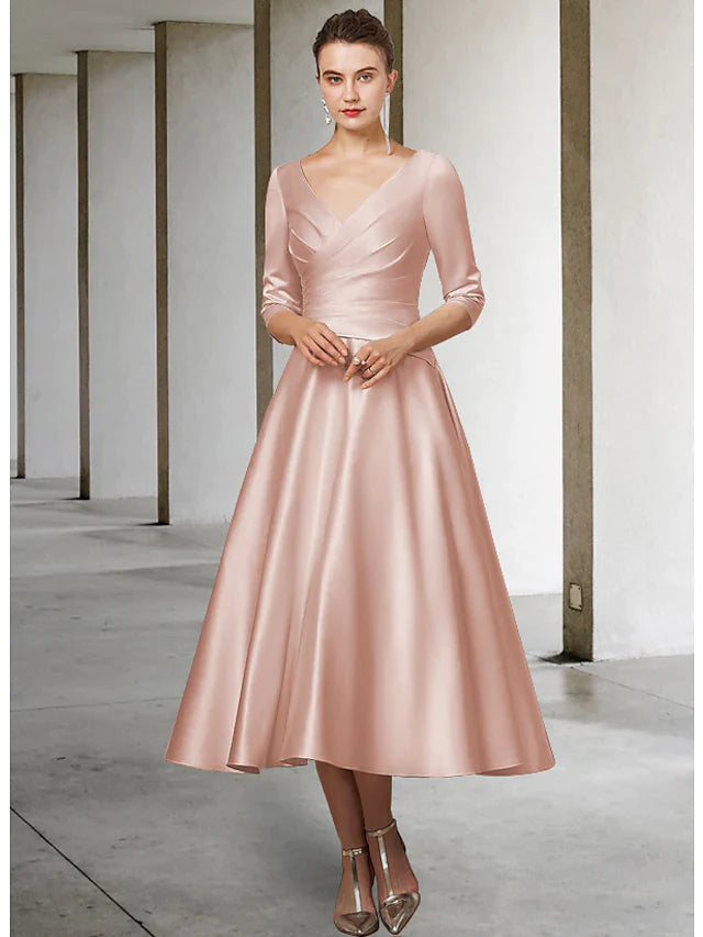 Close-up of the bodice of a blue A-line V-neck satin tea length Mother of the Bride dress with half sleeves.