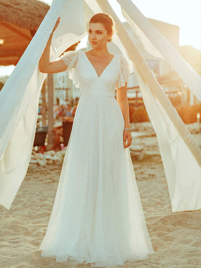 Model wearing an A-line V-neck short sleeve lace wedding dress, front view.