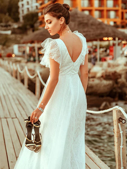 Back view of an A-line V-neck lace wedding dress with illusion detail.