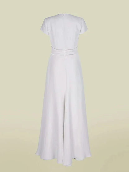 Side view of a flowing A-line charmeuse dress with short sleeves and pleats.