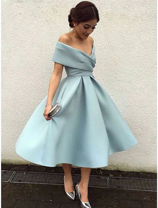 Woman wearing a dark blue A-line V-neck short sleeve tea length cocktail dress.
