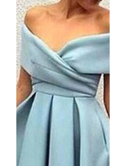 Woman in a light blue A-line V-neck short sleeve dress, showcasing the pleated V-back.