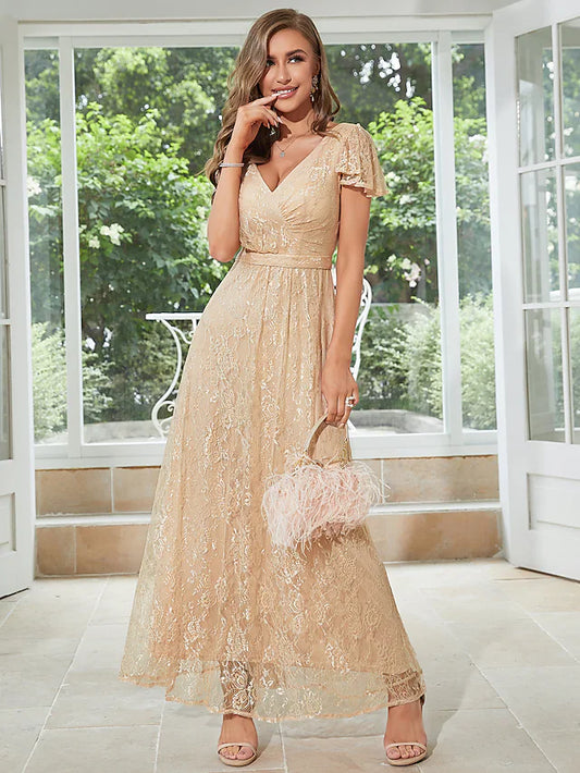 Woman wearing an elegant light-colored A-line chiffon dress with V-neck, short sleeves, and ruffles.