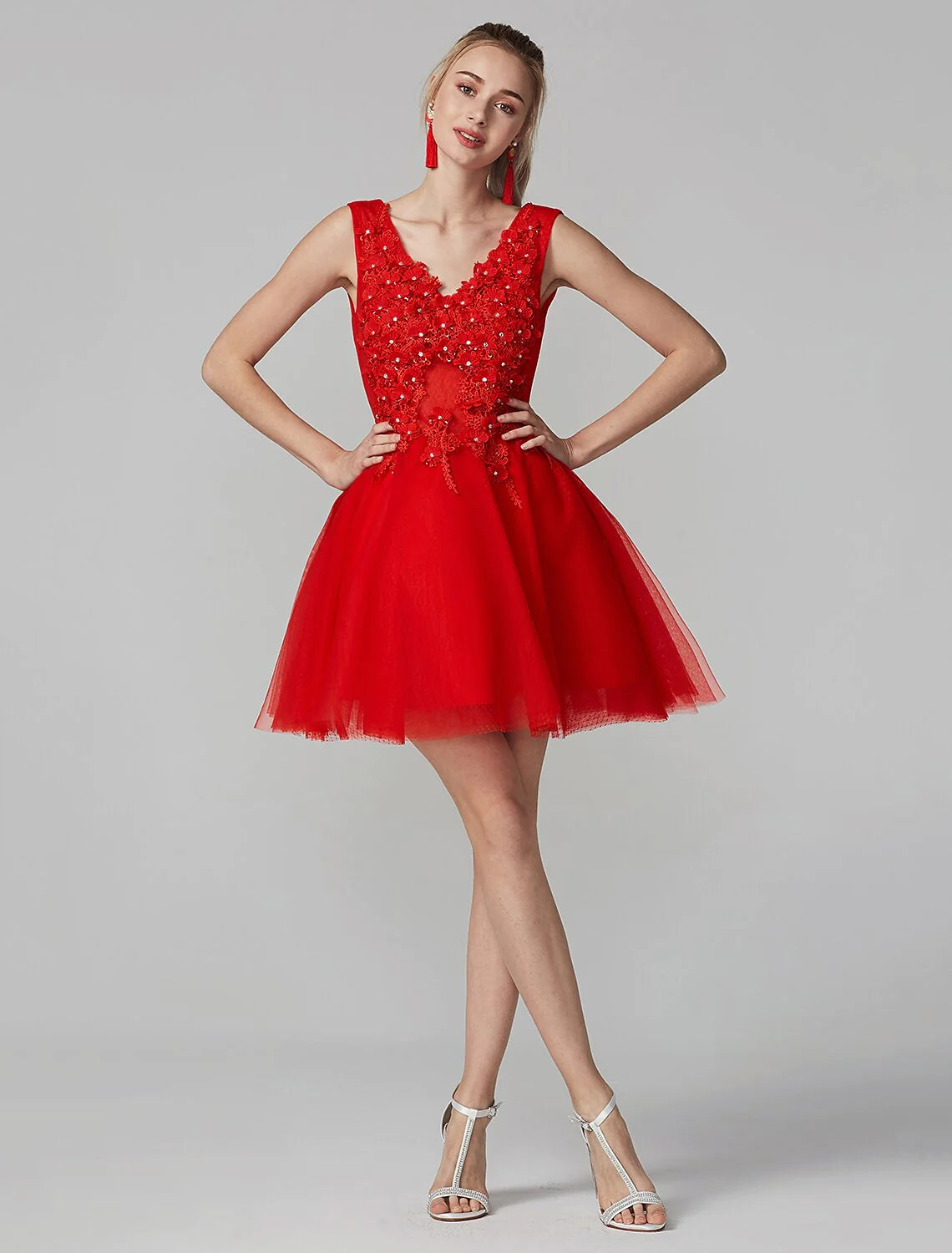 A-line V-neck sleeveless homecoming dress with lace and crystal appliques on a model.