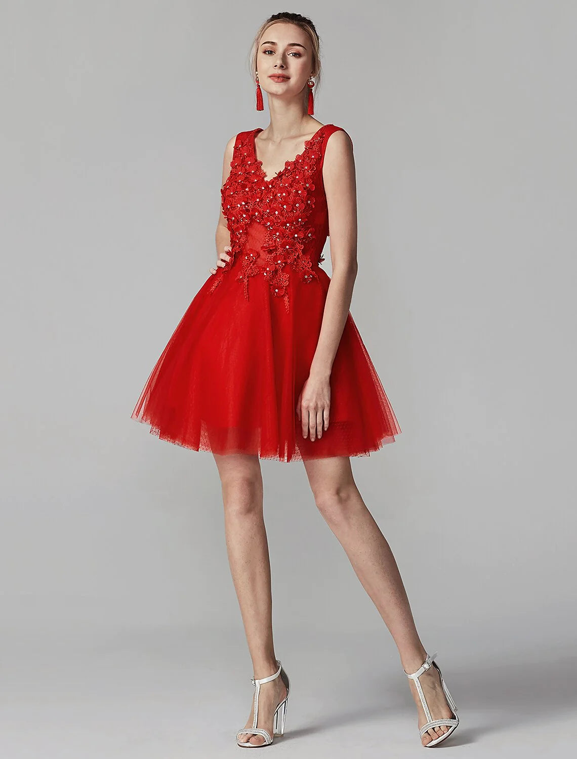 Close-up of crystal appliques and lace on tulle fabric of the party dress.