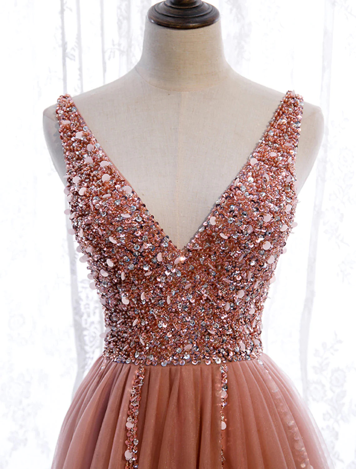 Close-up of the V-neck and pearl embroidery on the A-line prom dress.