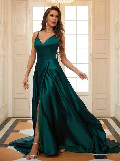 Woman in elegant A-line V-neck ruffled satin prom dress with court train, posing gracefully.