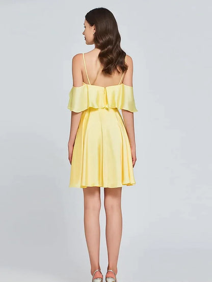 Side view of a model wearing a light pink A-line V-neck sleeveless satin pleated knee-length cocktail dress.