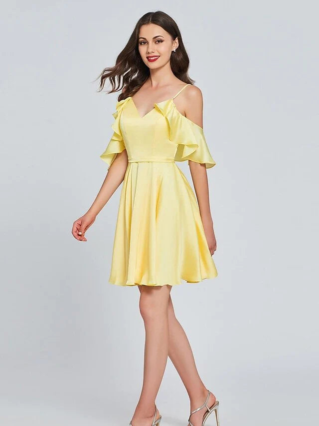 Close-up of the pleated satin fabric and V-neckline of the light pink A-line dress.