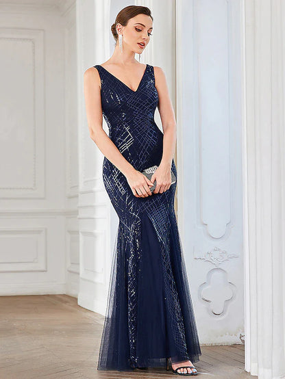 Woman wearing an elegant dark blue A-line sequin tulle V-neck dress.