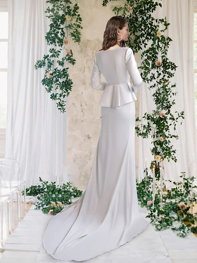 Back view of a satin wedding dress with a court train and delicate spaghetti straps.